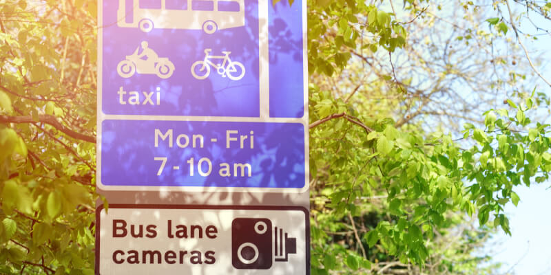 UK bus lane sign with timed restrictions displayed