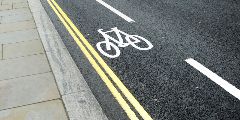 UK road markings showing double yellow lines and a cycle lane