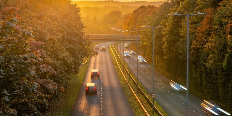 Sunset view of blurred cars on a dual carriageway